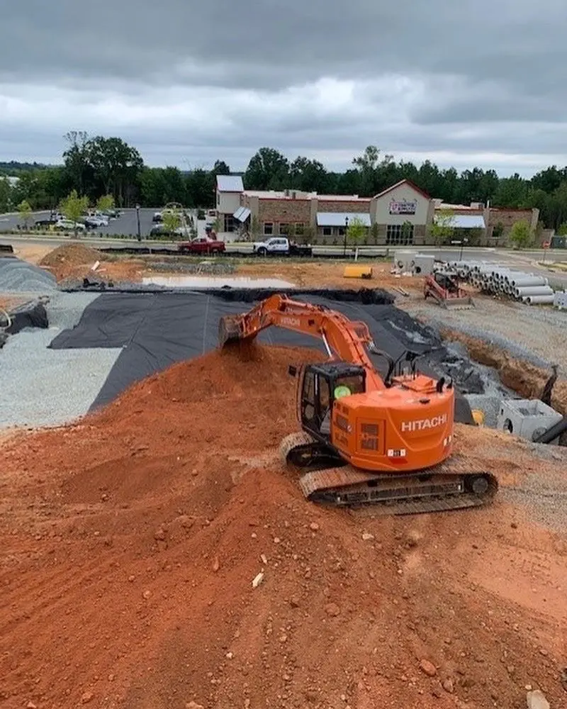 EC Grading excavator shaping a commercial construction site